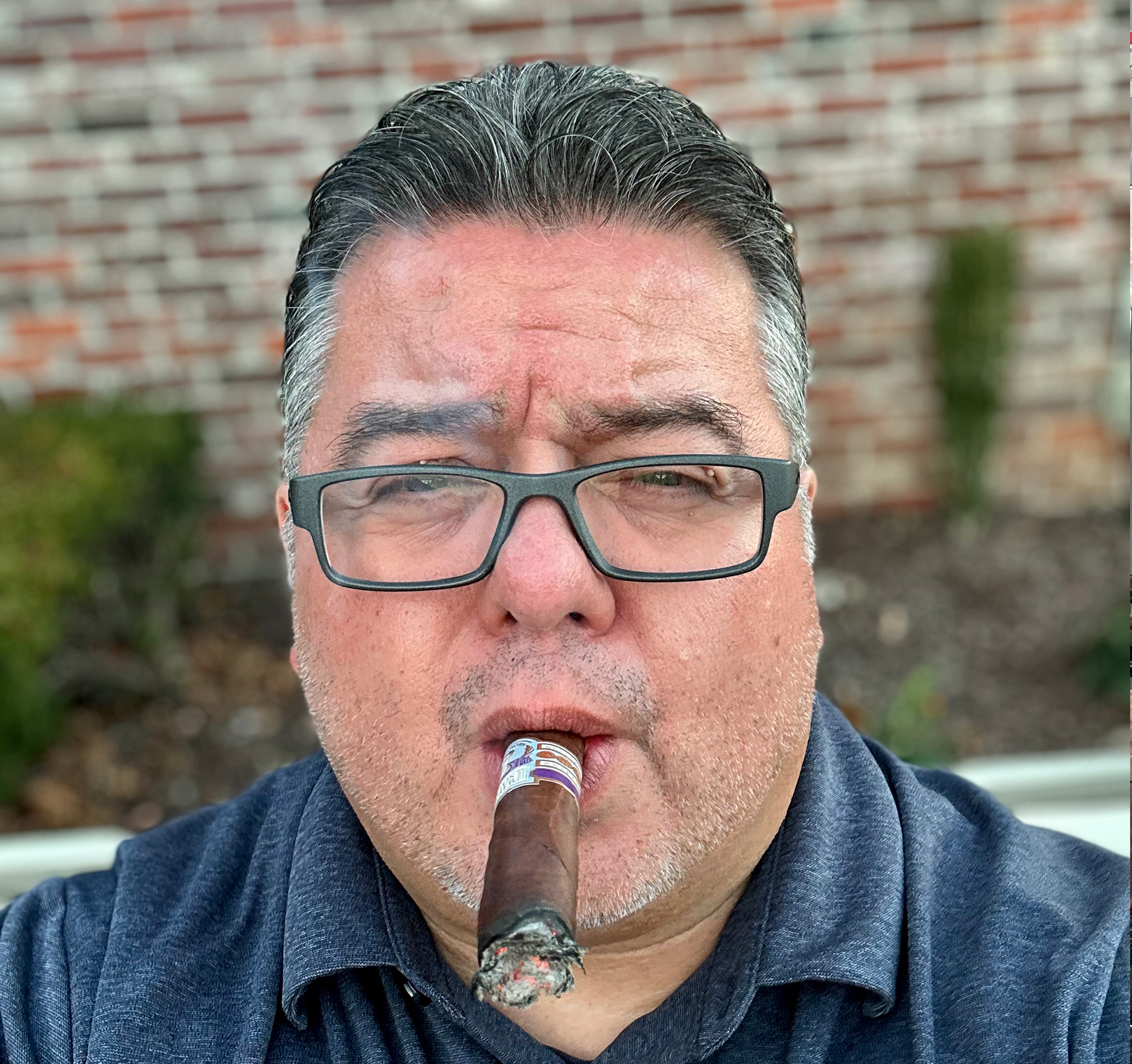 Boss Hector headshot with a cigar